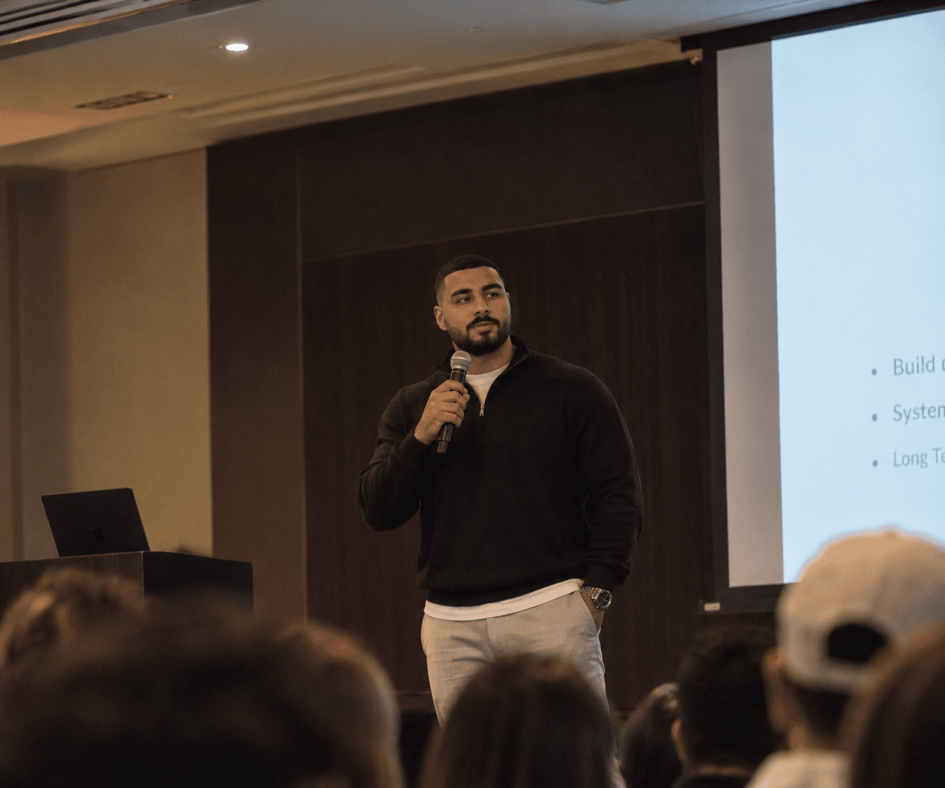 Zee speaking to a room of agents